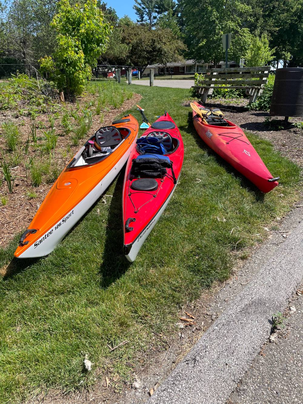three kayaks on grass